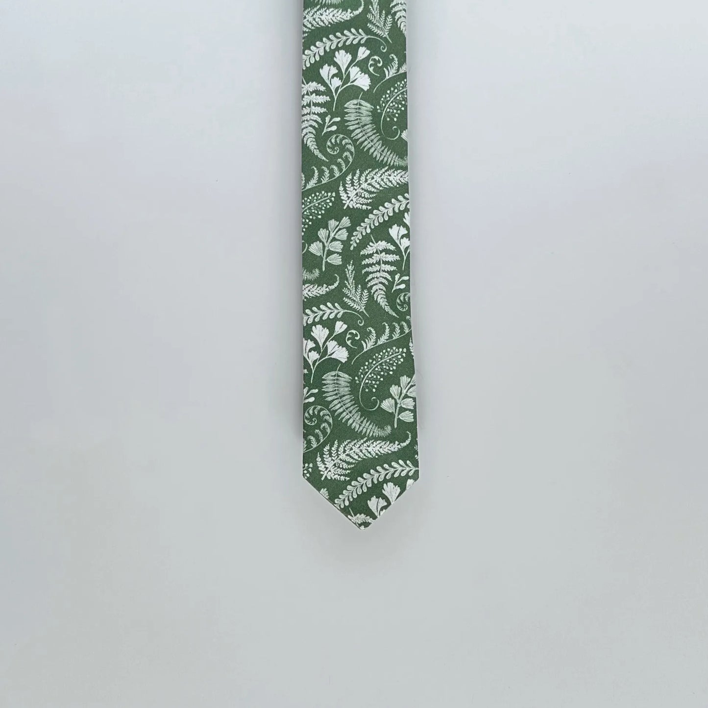 Elegant sage green tie with white florals, crafted from cotton and satin, ideal for weddings and business events.